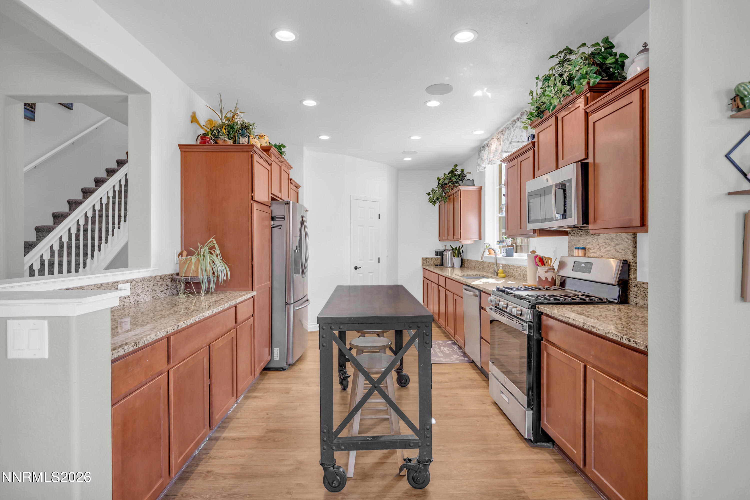 18648 Granite Peak Court Reno, NV 89508 - Photo 17 of 53 a kitchen with stainless steel appliances granite countertop a stove a sink dishwasher a microwave oven and a refrigerator