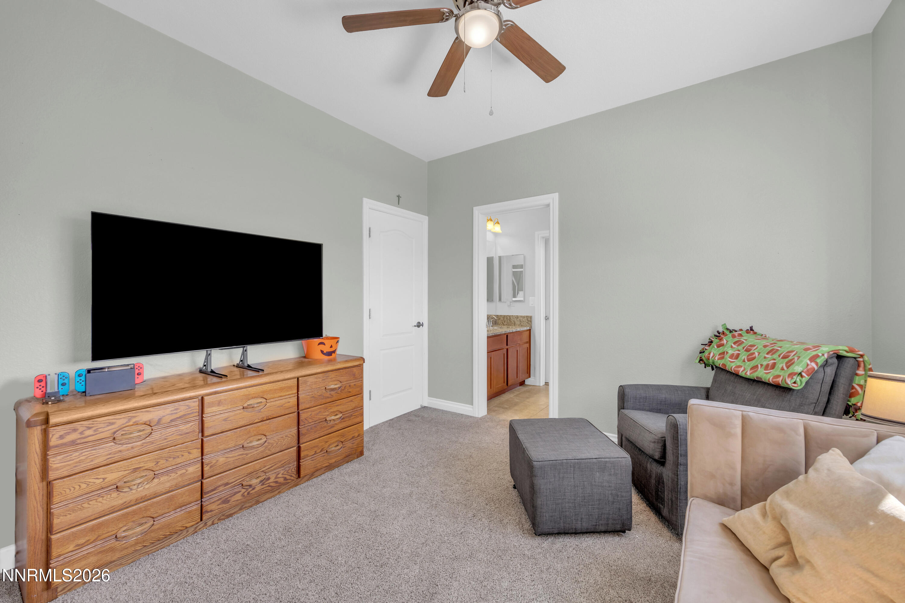 18648 Granite Peak Court Reno, NV 89508 - Photo 27 of 53 a living room with furniture and a flat screen tv