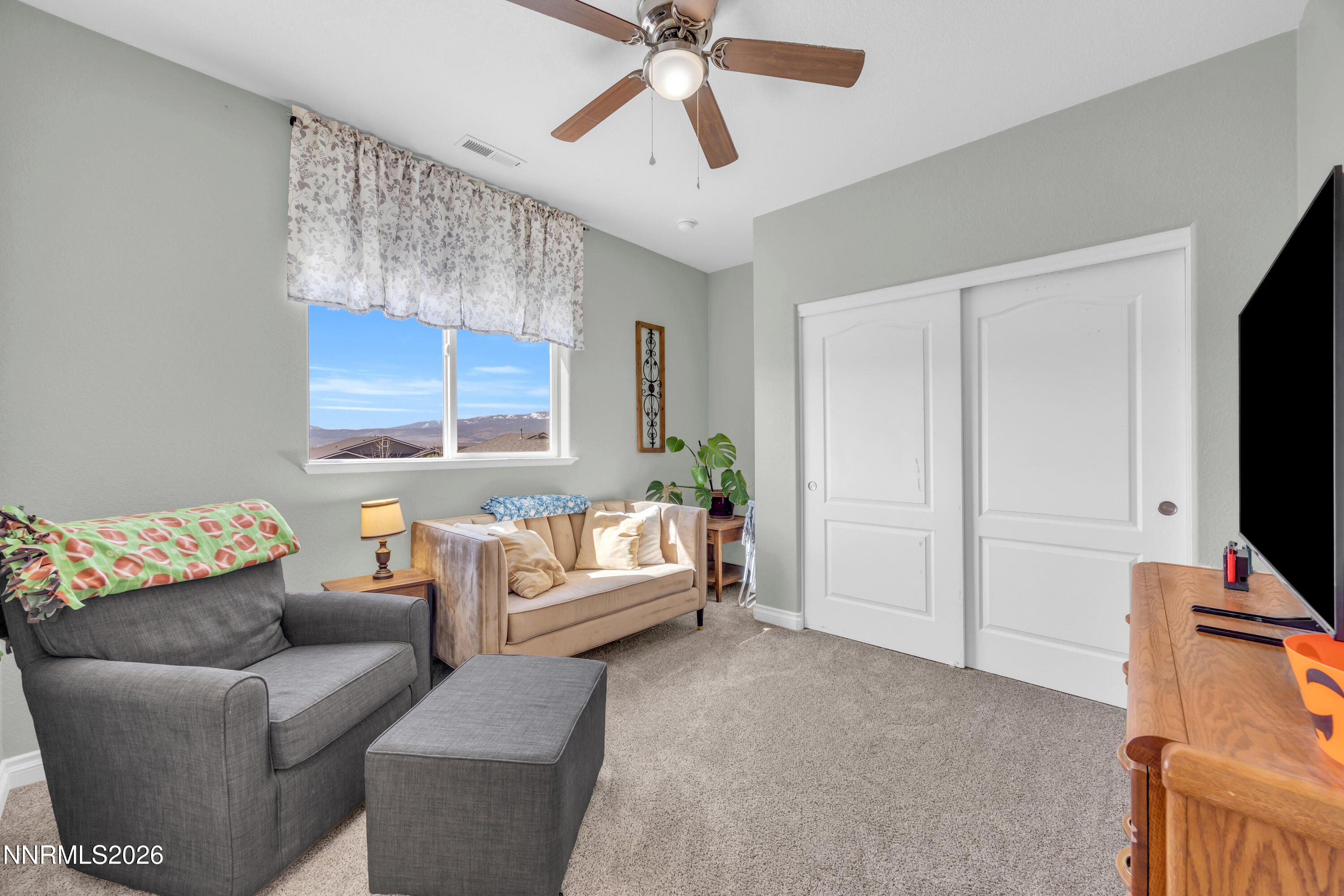 18648 Granite Peak Court Reno, NV 89508 - Photo 28 of 53 a living room with furniture and a flat screen tv