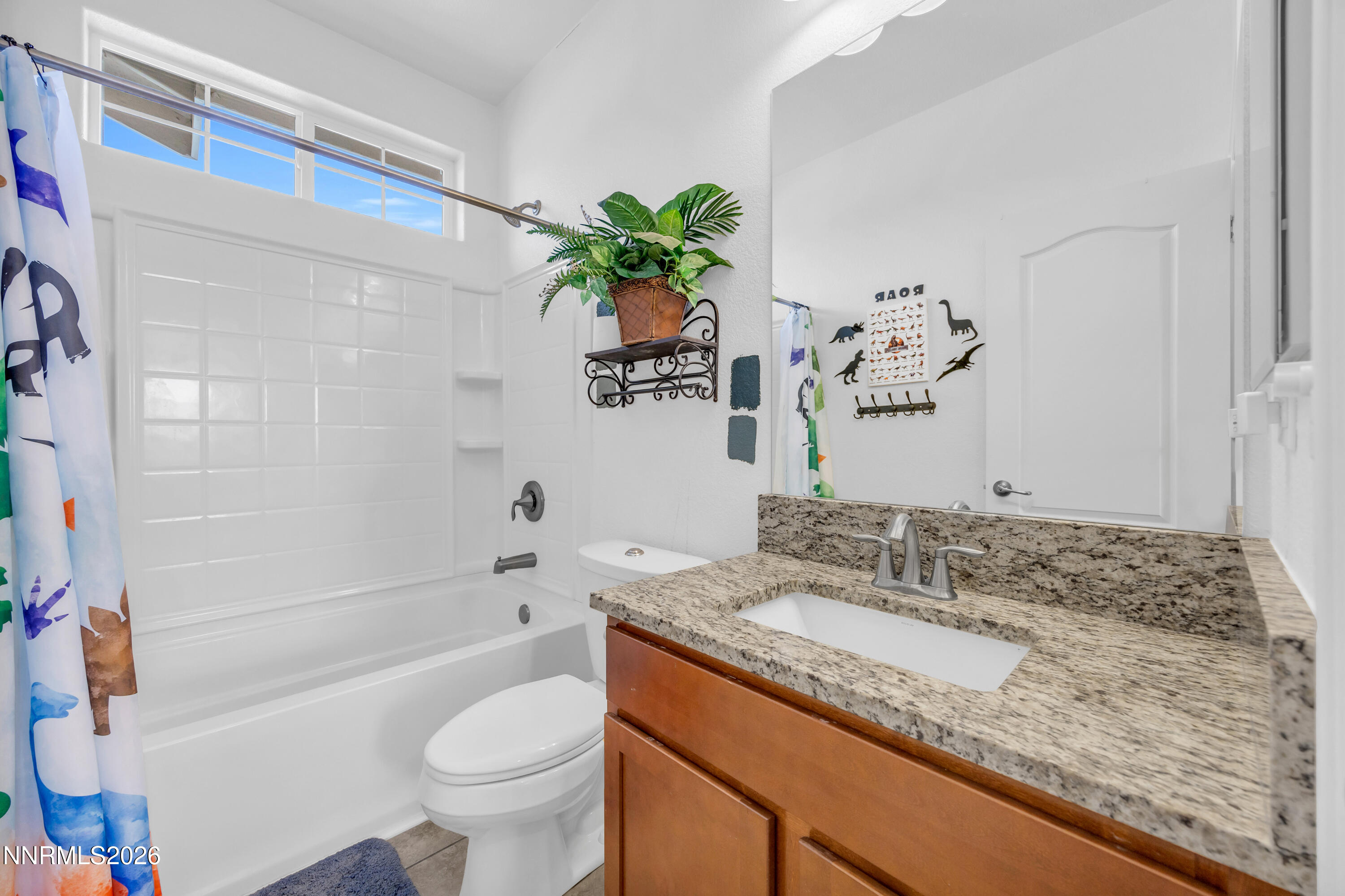 18648 Granite Peak Court Reno, NV 89508 - Photo 32 of 53 a bathroom with a granite countertop sink a toilet and bathtub