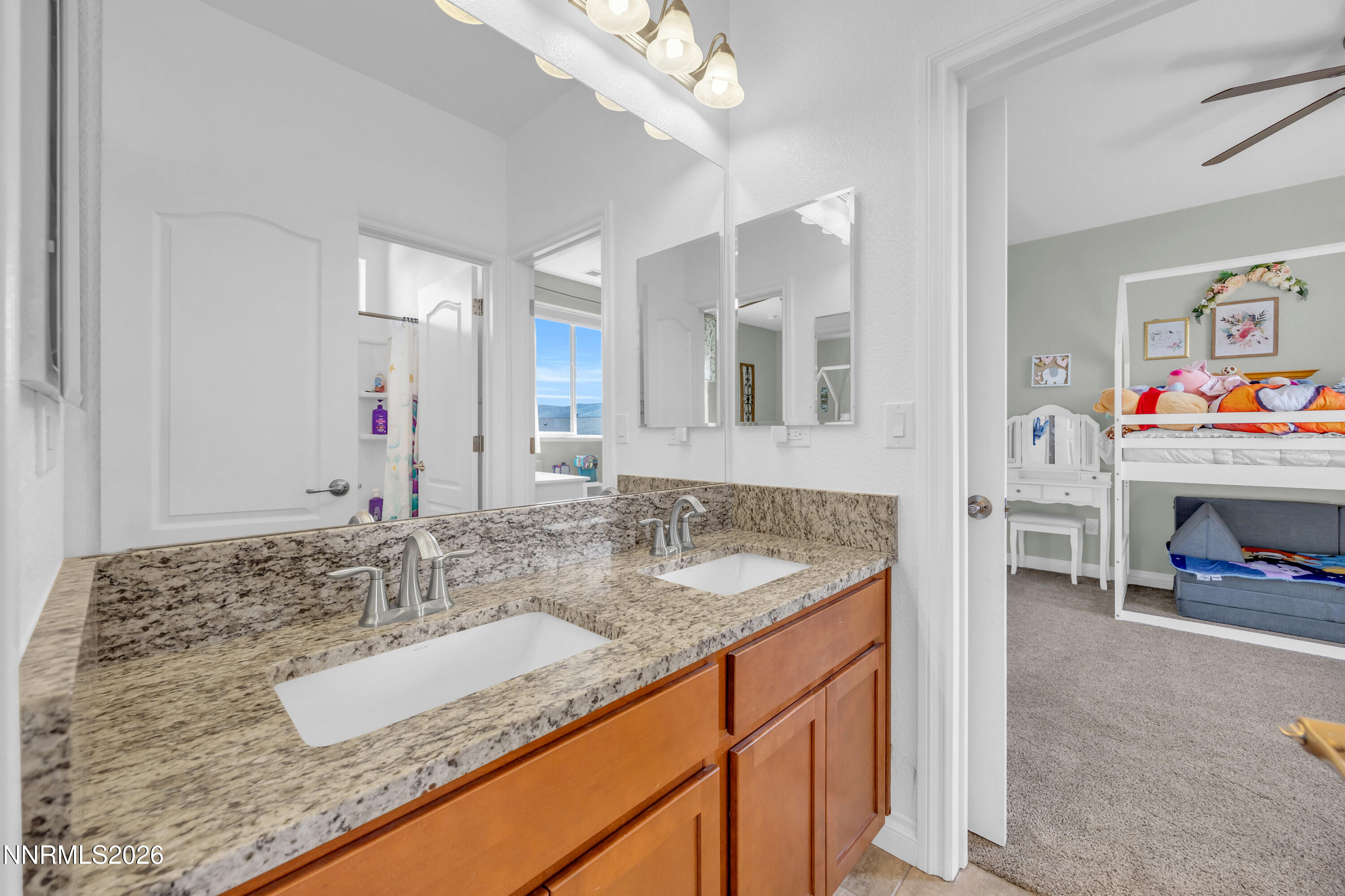 18648 Granite Peak Court Reno, NV 89508 - Photo 33 of 53 a bathroom with sink granite and a mirror