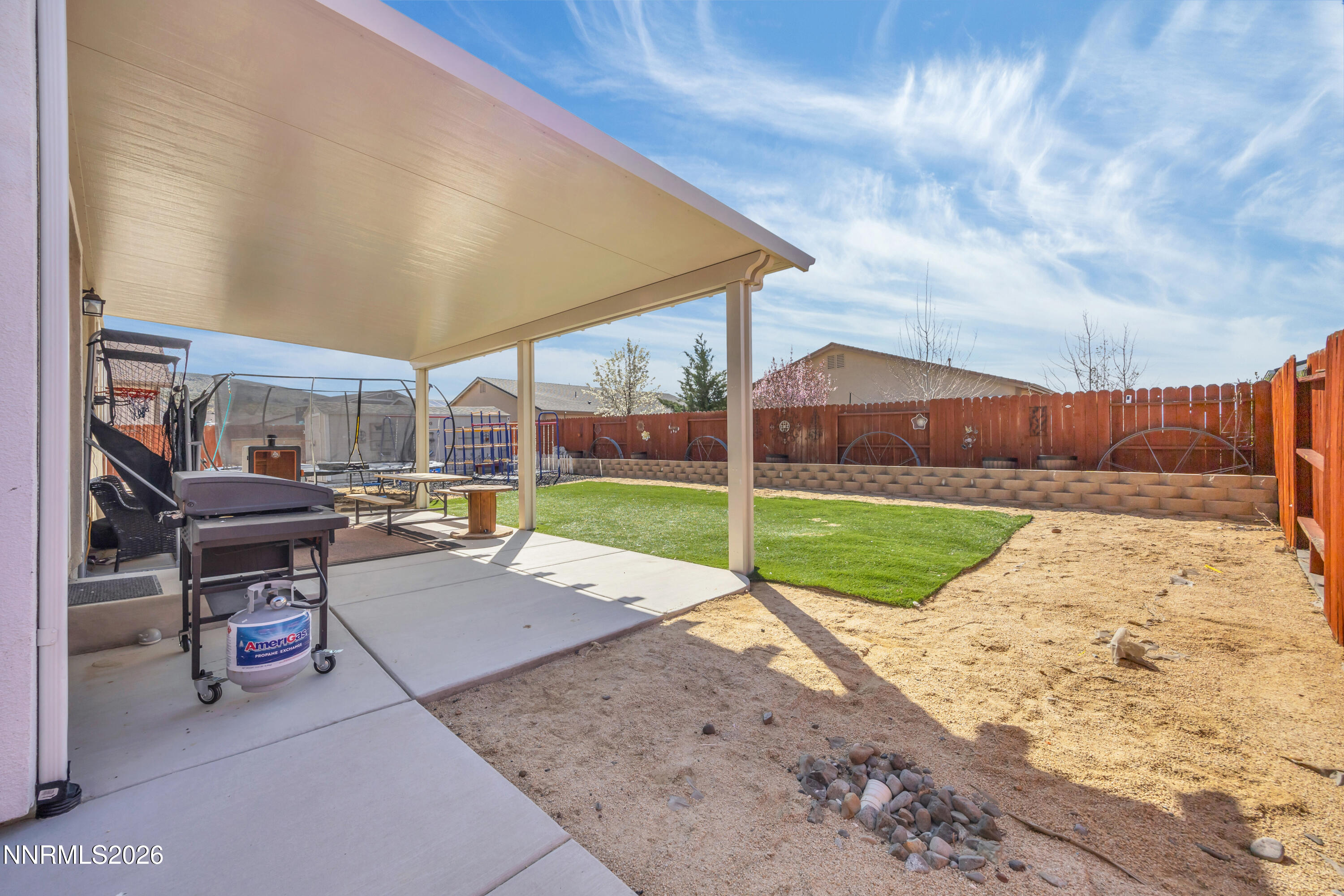 18648 Granite Peak Court Reno, NV 89508 - Photo 43 of 53 a view of a backyard with table and chairs under an umbrella
