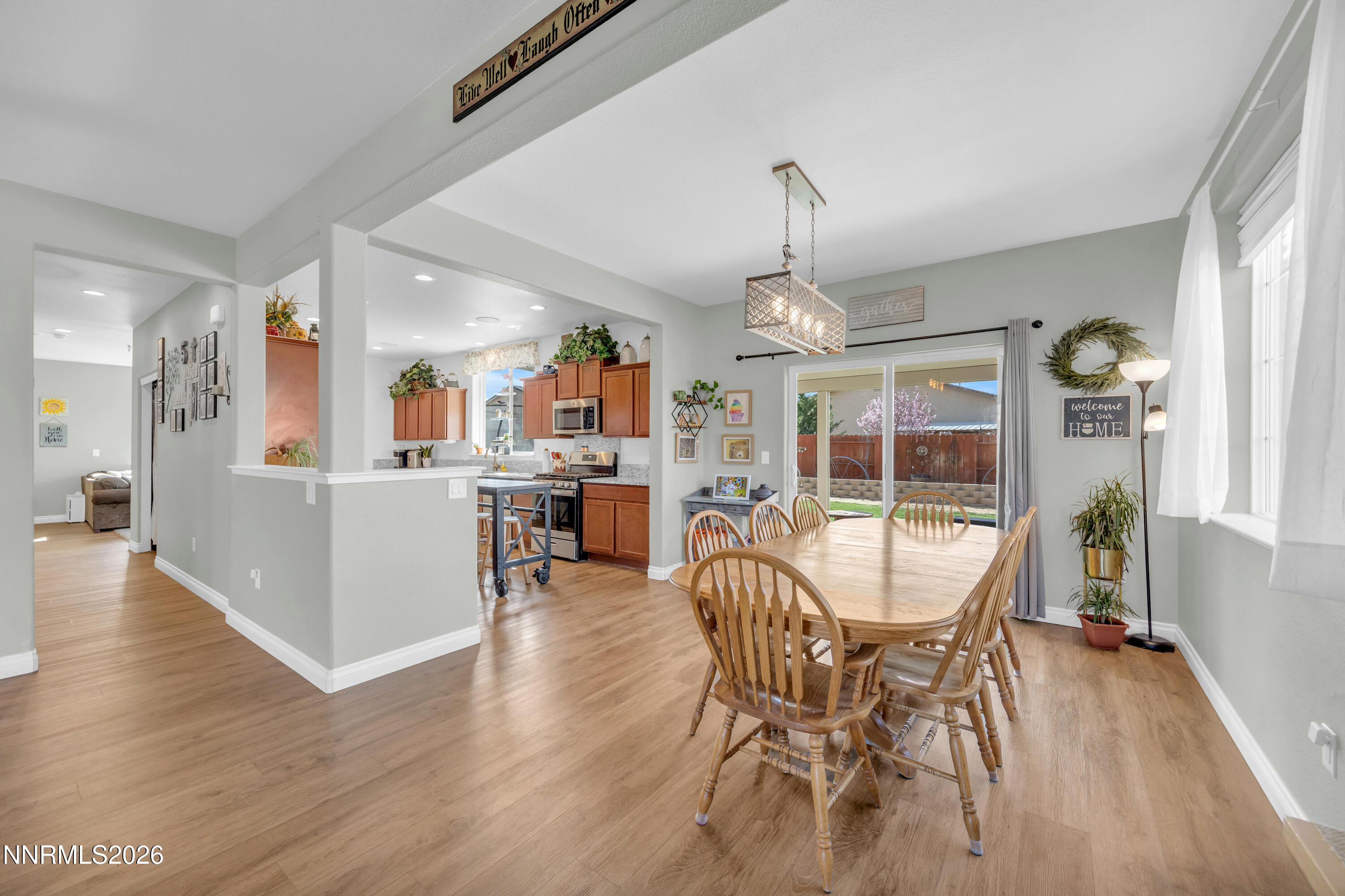 18648 Granite Peak Court Reno, NV 89508 - Photo 9 of 53 a view of a dining room and livingroom with furniture wooden floor a chandelier