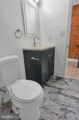 a bathroom with a sink a toilet and a mirror