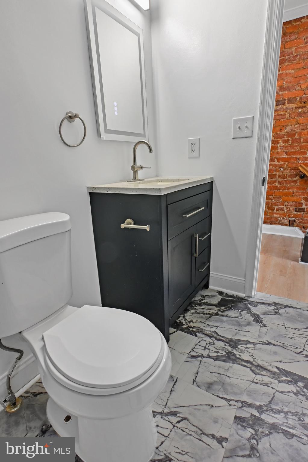 1702 A Street Southeast Washington, DC 20003 - Photo 11 of 24 a bathroom with a sink a toilet and a mirror