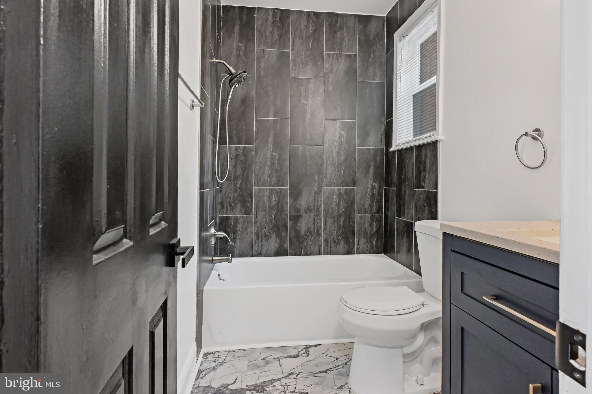 1702 A Street Southeast Washington, DC 20003 - Photo 16 of 24 a bathroom with a granite countertop bathtub shower sink vanity and toilet