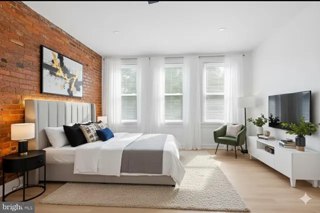 a bedroom with a bed and flat screen tv