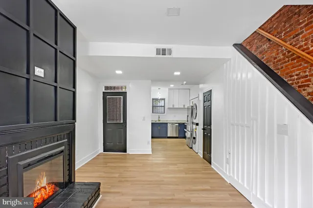 a view of a kitchen with a sink and a refrigerator