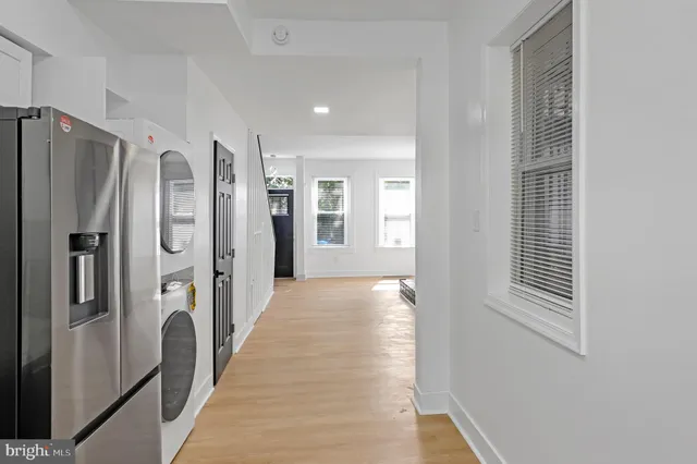 a view of a hallway with windows and closet