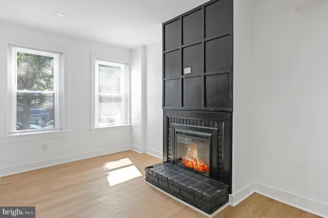 a living room with fireplace furniture and a window