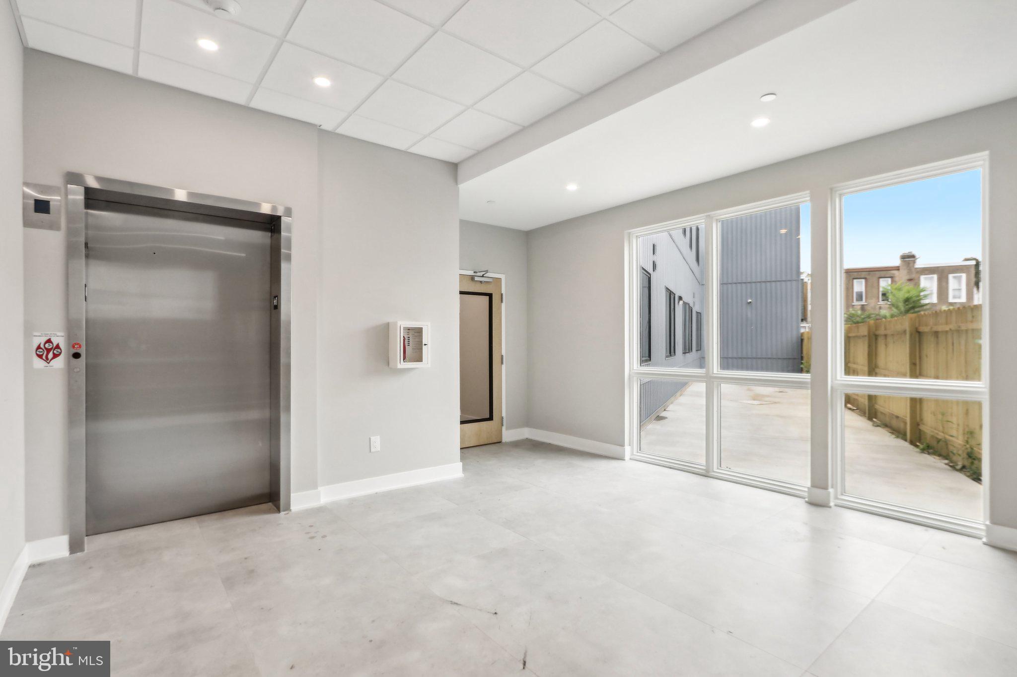 1622 Point Breeze Avenue, Unit 410 Philadelphia, PA 19145 - Photo 15 of 20 an empty room with glass door and shower