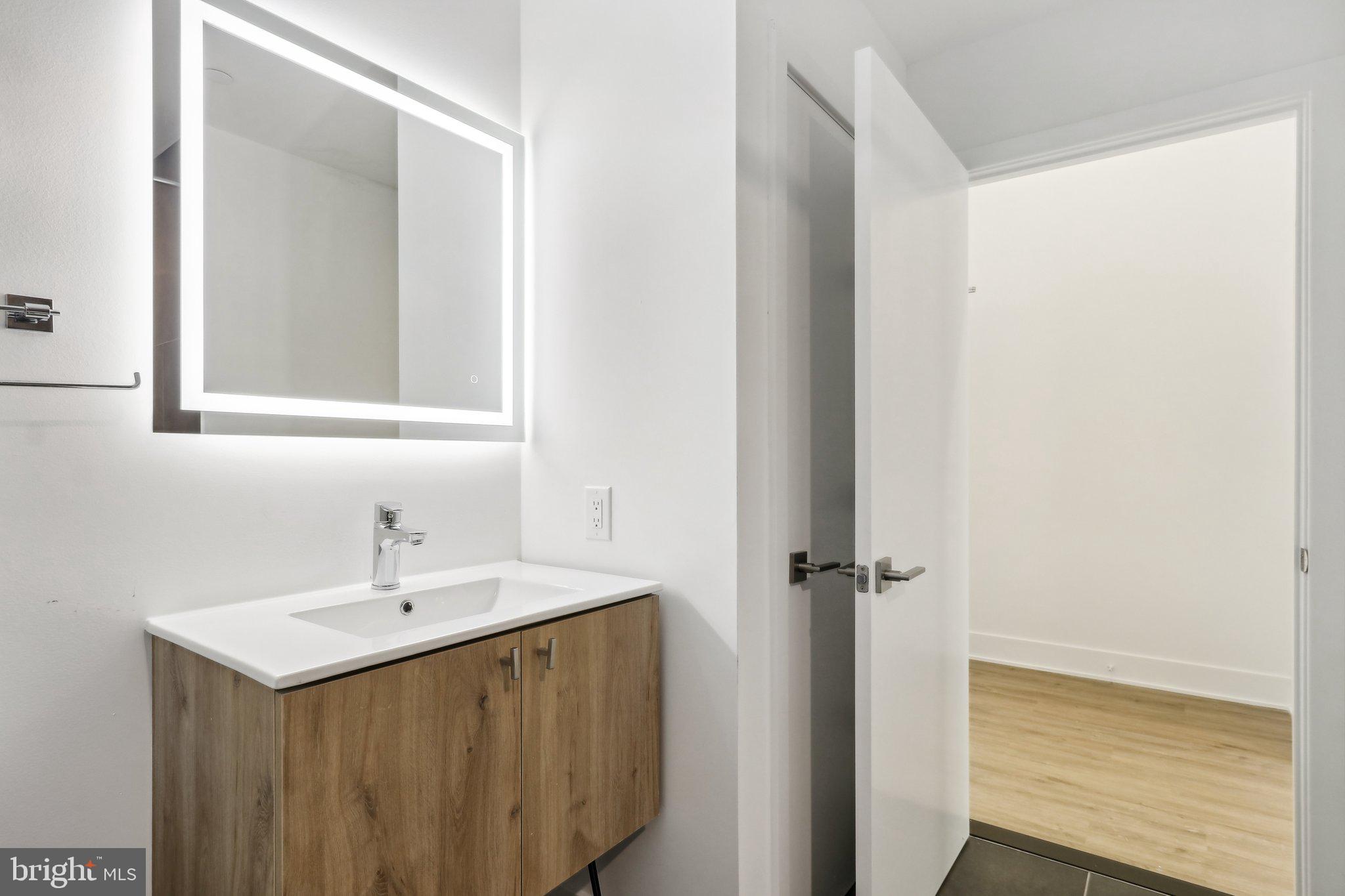 1622 Point Breeze Avenue, Unit 410 Philadelphia, PA 19145 - Photo 6 of 20 a bathroom with a sink and a mirror