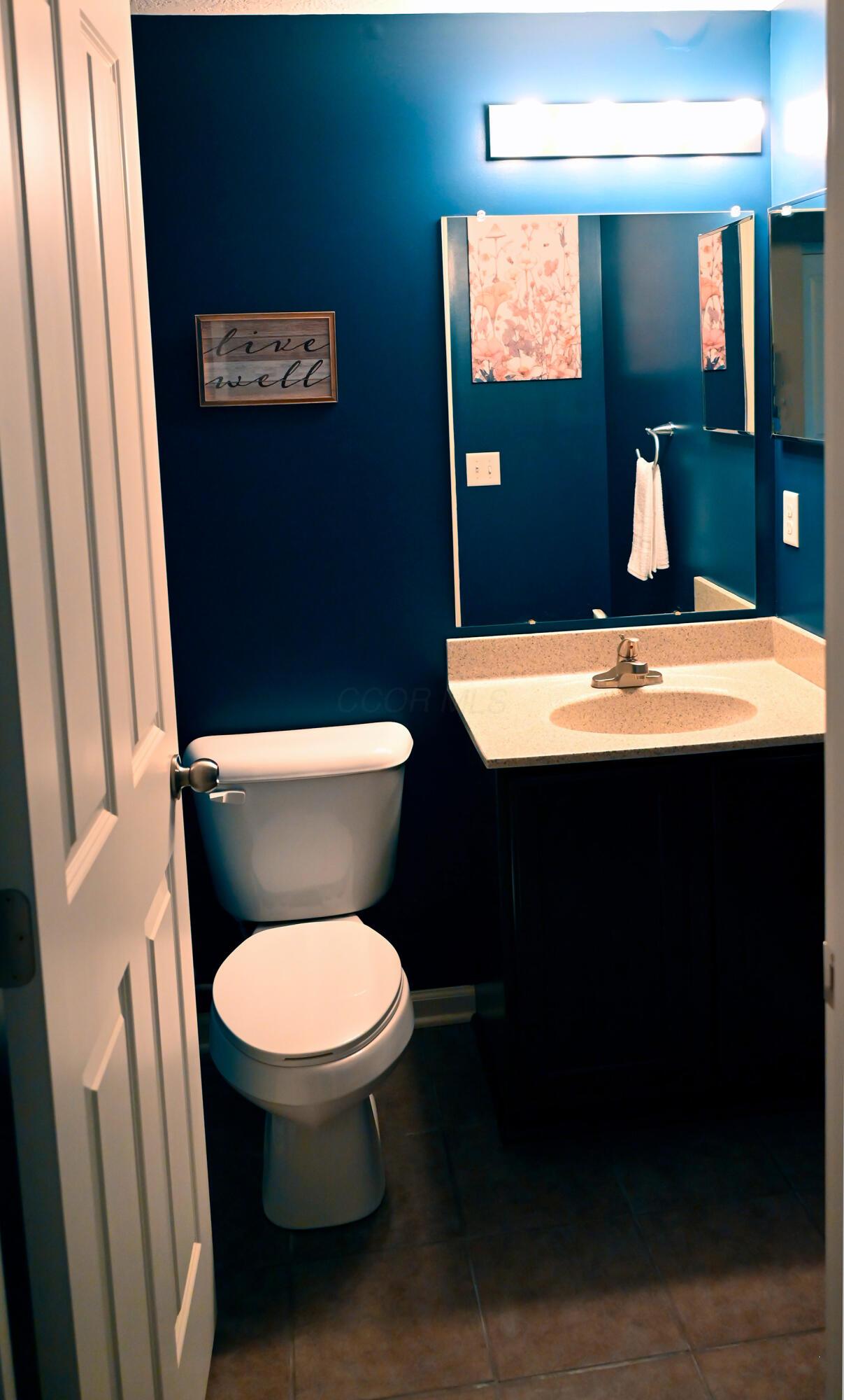 8289 Bruntsfield Road Columbus, OH 43235 - Photo 17 of 36 Well-appointed half bath featuring contemporary finishes, ample mirror space, and a convenient location serving the main level of the home.