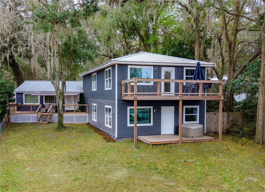 1353 Chatauqua Way Keystone Heights, FL 32656 - Photo 1 of 60 a front view of a house with a garden and trees