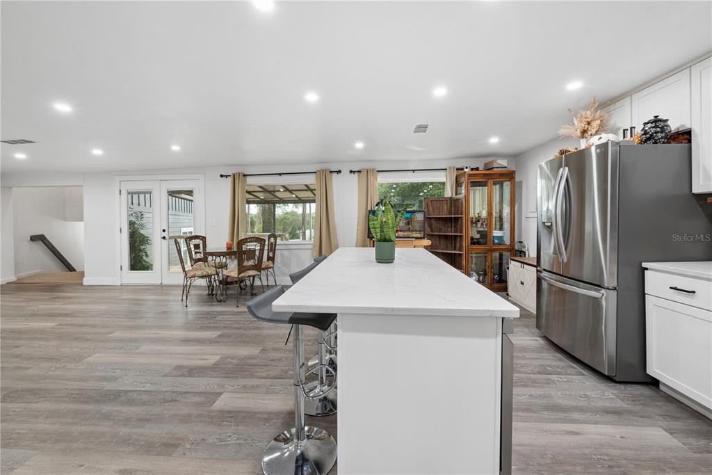 1353 Chatauqua Way Keystone Heights, FL 32656 - Photo 19 of 60 a kitchen with stainless steel appliances a refrigerator a counter space and a center island