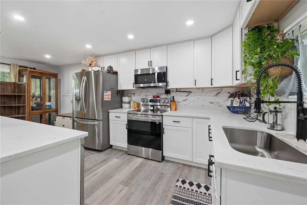 1353 Chatauqua Way Keystone Heights, FL 32656 - Photo 20 of 60 a kitchen with a refrigerator and a sink
