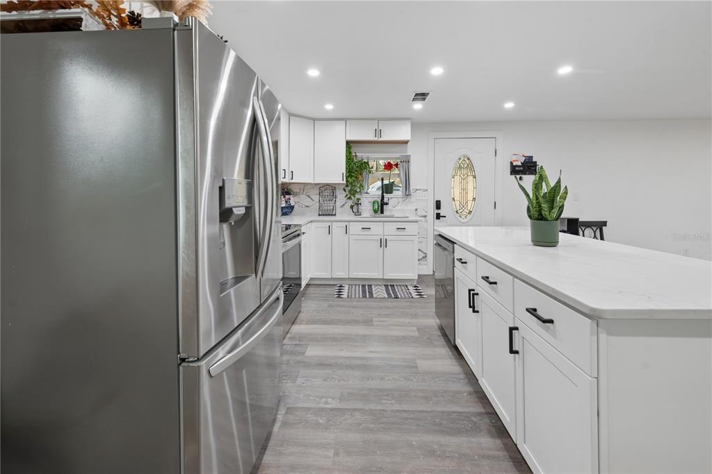 1353 Chatauqua Way Keystone Heights, FL 32656 - Photo 22 of 60 a kitchen with white cabinets and white appliances