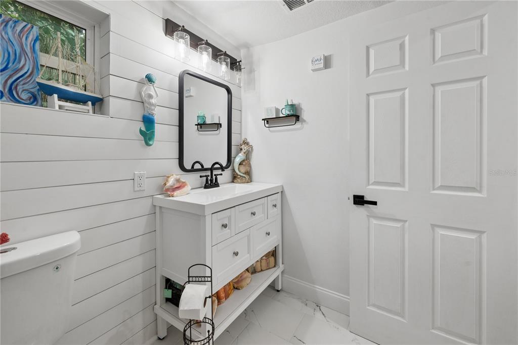 1353 Chatauqua Way Keystone Heights, FL 32656 - Photo 26 of 60 a bathroom with a sink and mirror