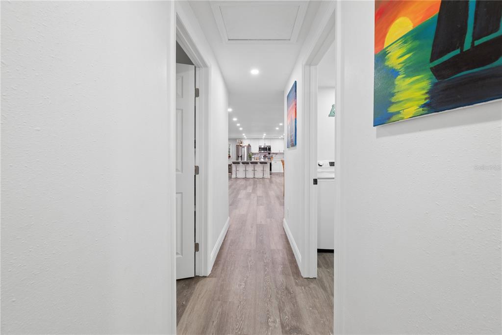 1353 Chatauqua Way Keystone Heights, FL 32656 - Photo 27 of 60 a view of a hallway with wooden floor and a bathroom