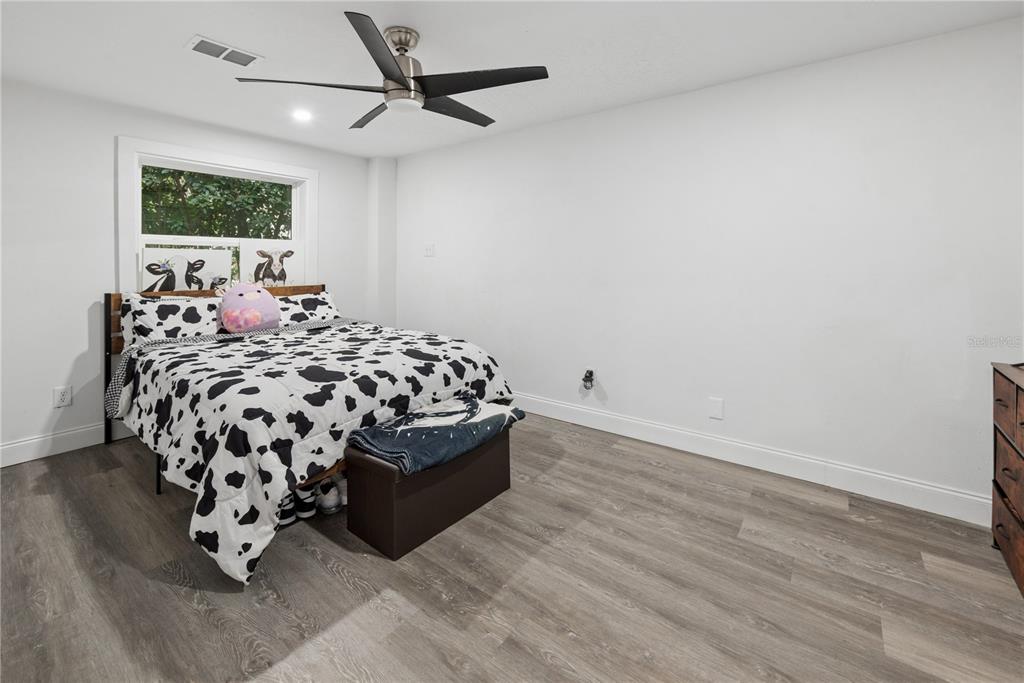 1353 Chatauqua Way Keystone Heights, FL 32656 - Photo 28 of 60 a bed sitting in a bedroom next to a window with a bedroom