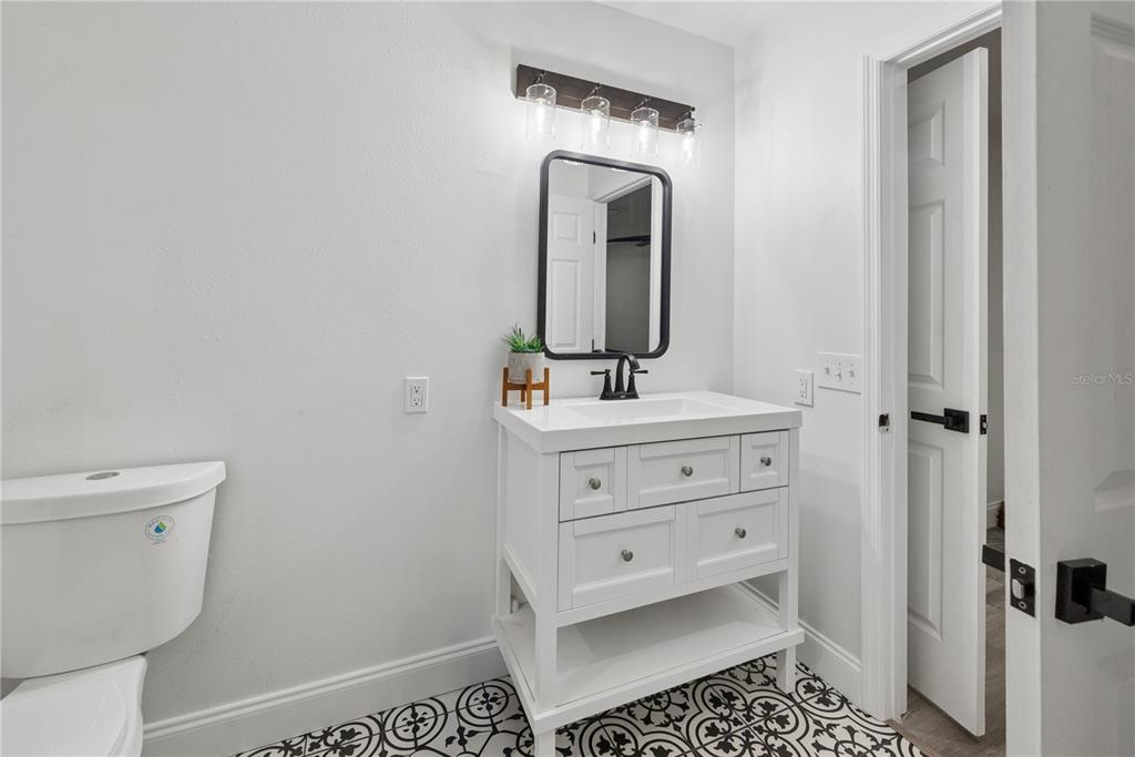 1353 Chatauqua Way Keystone Heights, FL 32656 - Photo 39 of 60 a bathroom with a sink a toilet and mirror