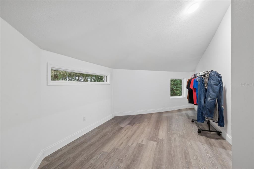 1353 Chatauqua Way Keystone Heights, FL 32656 - Photo 40 of 60 an empty room with a wooden floor and closet