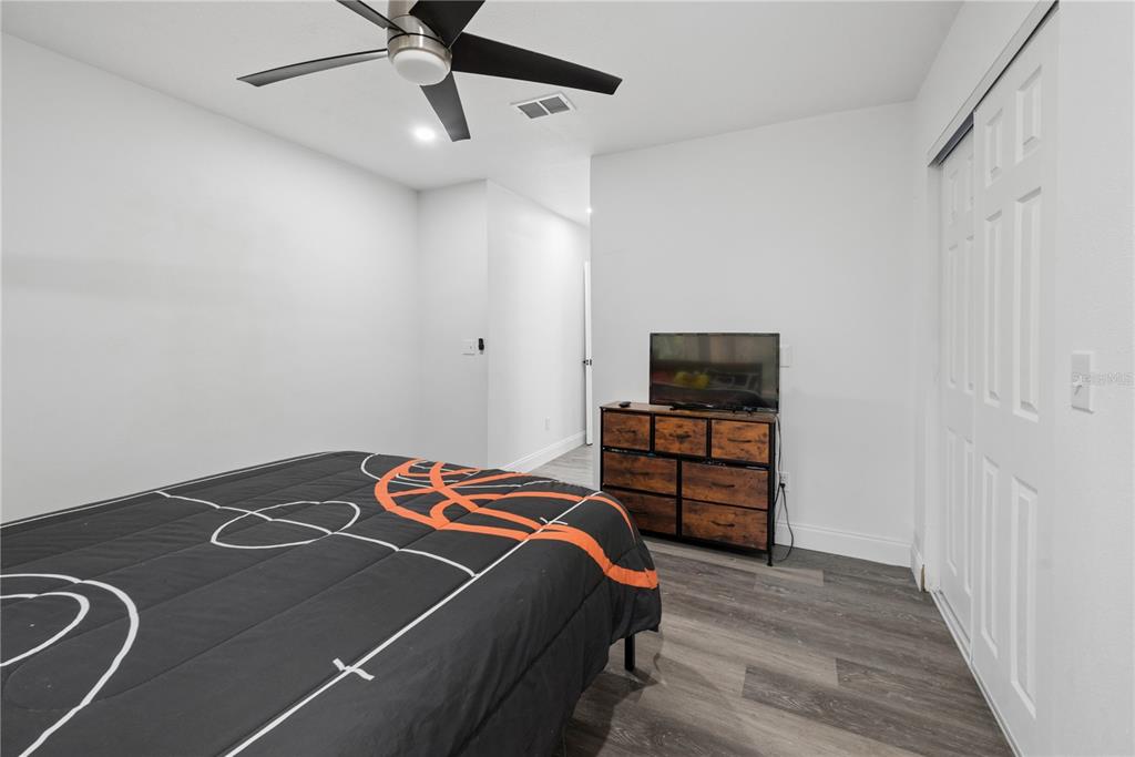 1353 Chatauqua Way Keystone Heights, FL 32656 - Photo 42 of 60 a bedroom with a bed and a ceiling fan