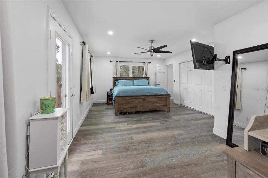 1353 Chatauqua Way Keystone Heights, FL 32656 - Photo 43 of 60 a spacious bedroom with a bed and a flat screen tv