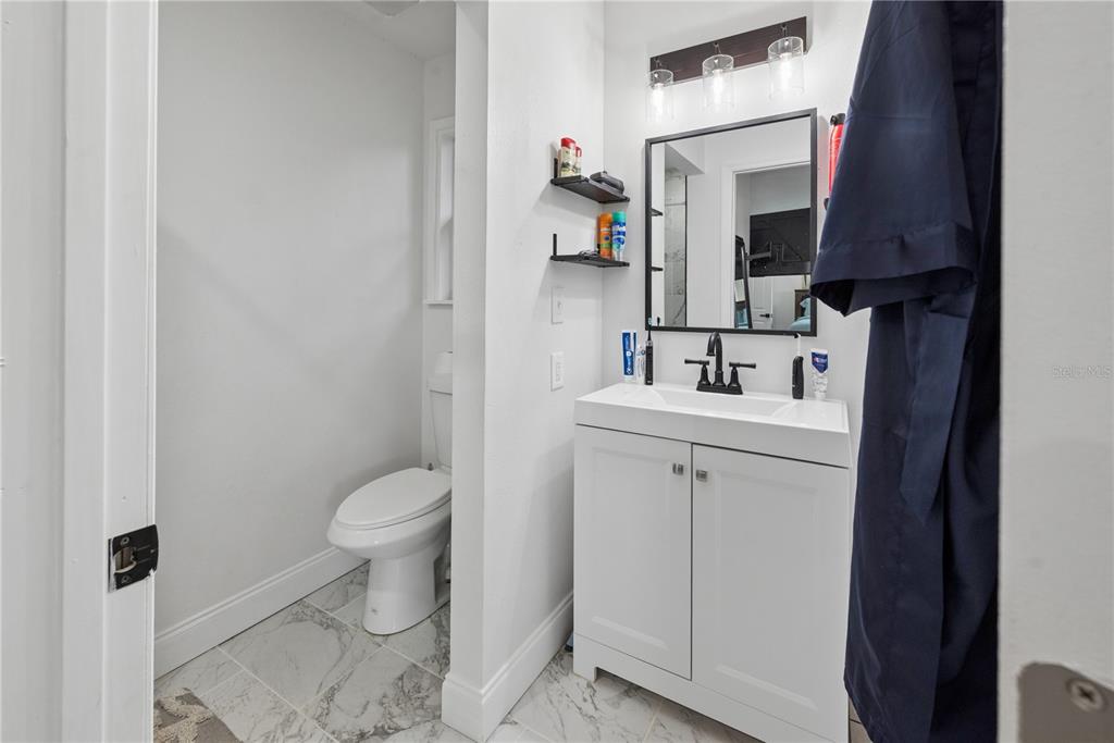 1353 Chatauqua Way Keystone Heights, FL 32656 - Photo 46 of 60 a bathroom with a sink toilet and mirror