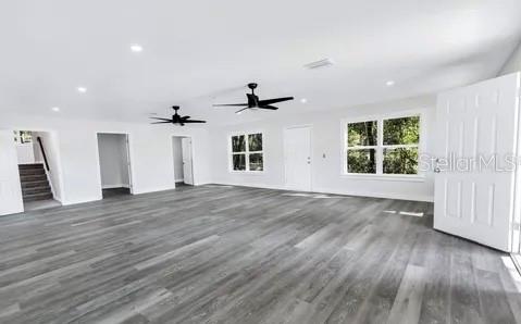 1353 Chatauqua Way Keystone Heights, FL 32656 - Photo 50 of 60 an empty room with wooden floor cabinet and windows