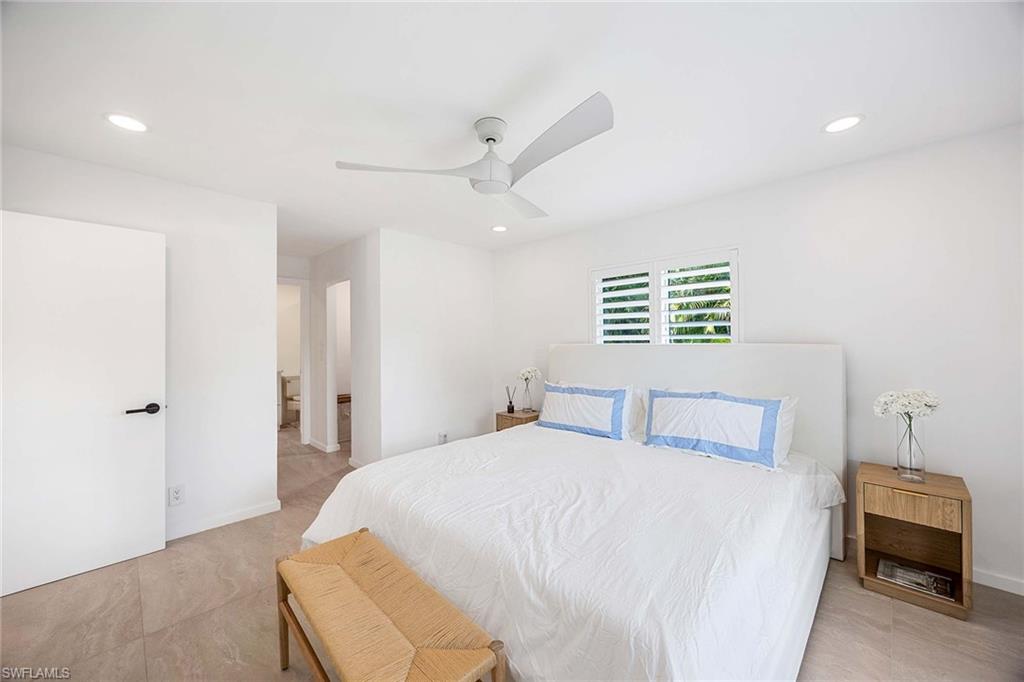 24 Rivard Road Naples, FL 34112 - Photo 18 of 29 a bedroom with a bed and a ceiling fan