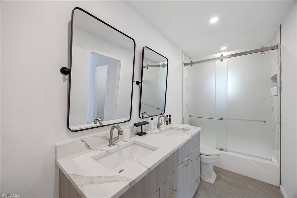 24 Rivard Road Naples, FL 34112 - Photo 20 of 29 a bathroom with a sink toilet double vanity and shower