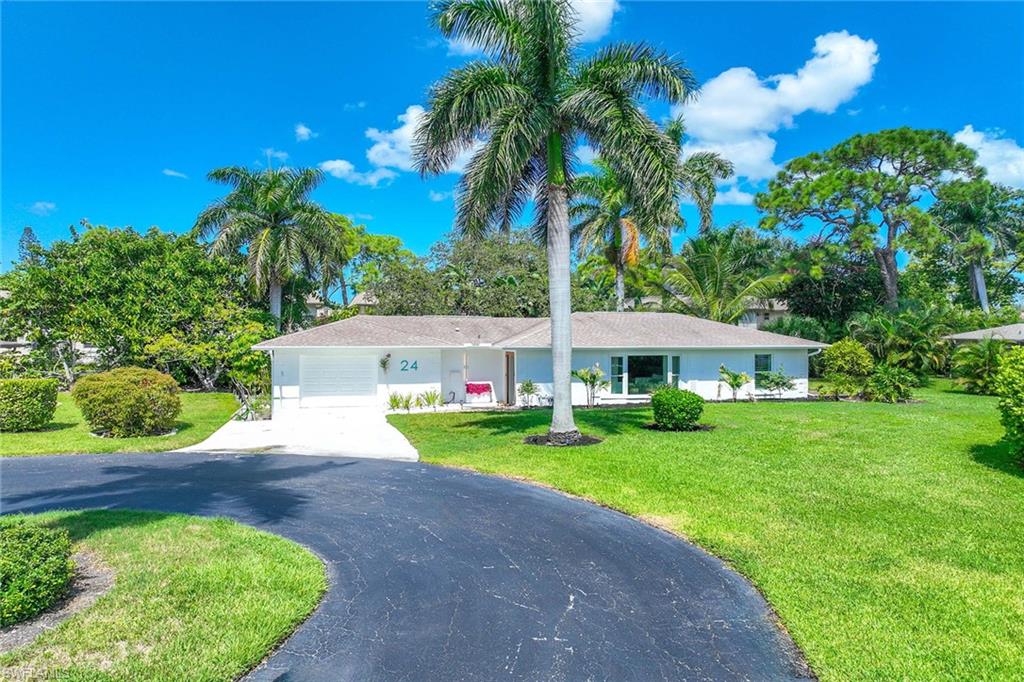 24 Rivard Road Naples, FL 34112 - Photo 2 of 29 a front view of a house with garden