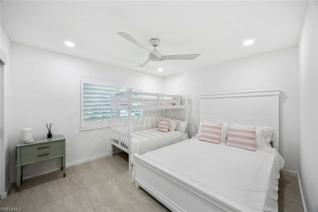 24 Rivard Road Naples, FL 34112 - Photo 21 of 29 a bedroom with a bed and a window