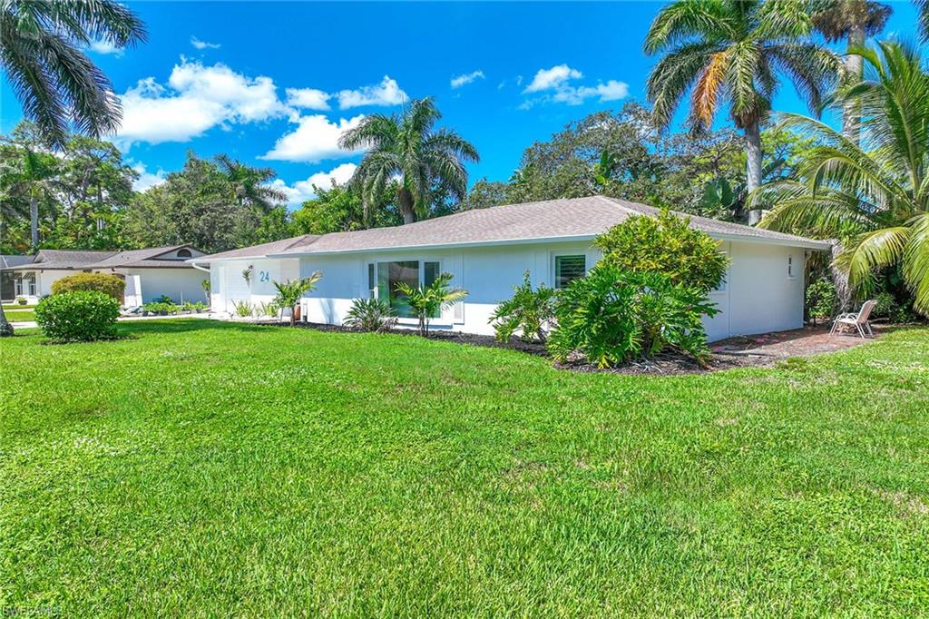 24 Rivard Road Naples, FL 34112 - Photo 27 of 29 a front view of a house with garden