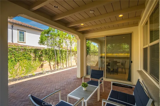 a view of a patio with table and chairs next to a yard