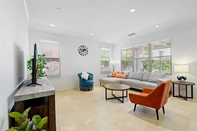 a living room with furniture and a potted plant