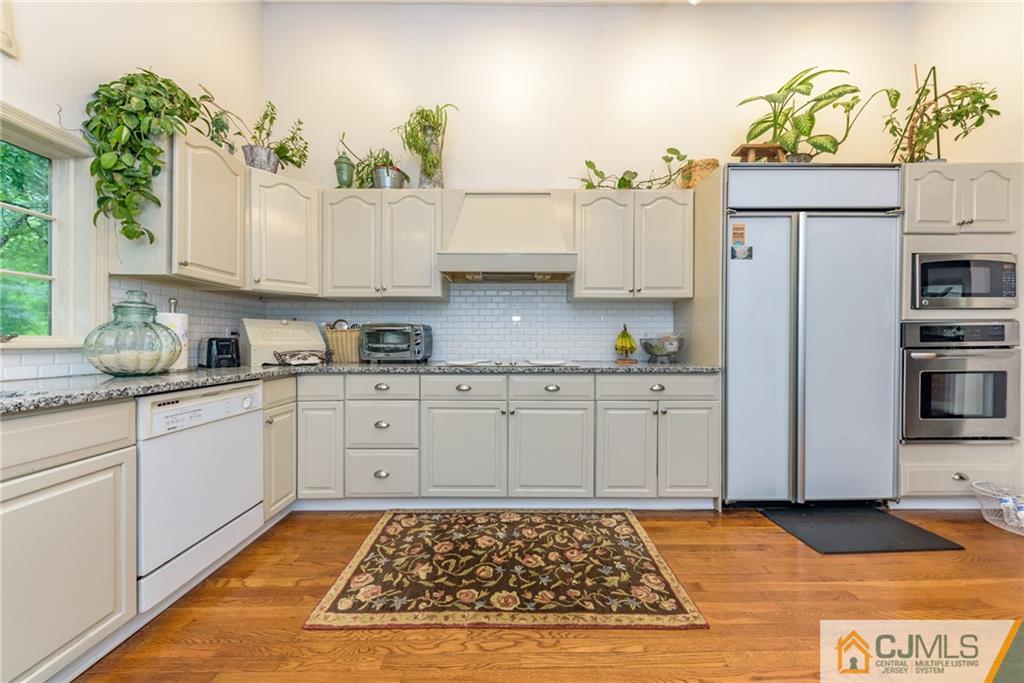 7 Bradford Road Edison, NJ 08820 - Photo 14 of 34 a kitchen with kitchen island granite countertop a sink stove and cabinets