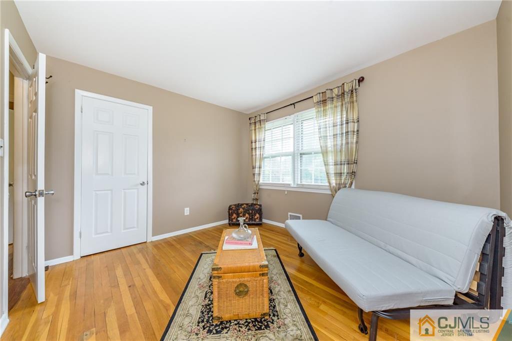 7 Bradford Road Edison, NJ 08820 - Photo 22 of 34 a bed sitting in a bedroom next to a window