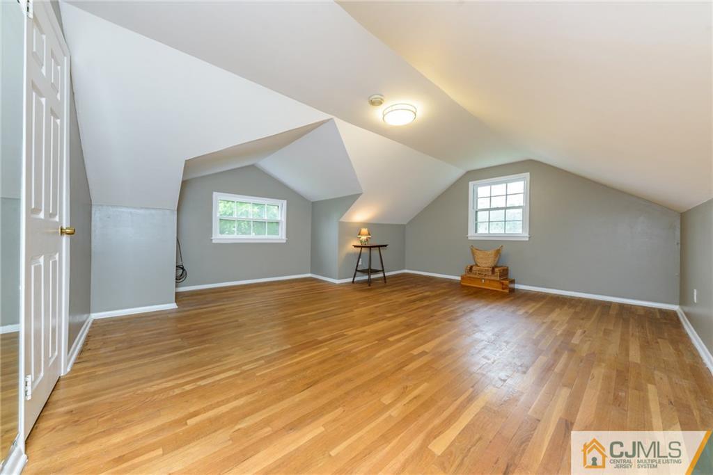 7 Bradford Road Edison, NJ 08820 - Photo 24 of 34 a view of empty room with window and wooden floor