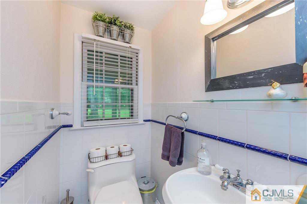 7 Bradford Road Edison, NJ 08820 - Photo 26 of 34 a bathroom with a sink vanity mirror and toilet