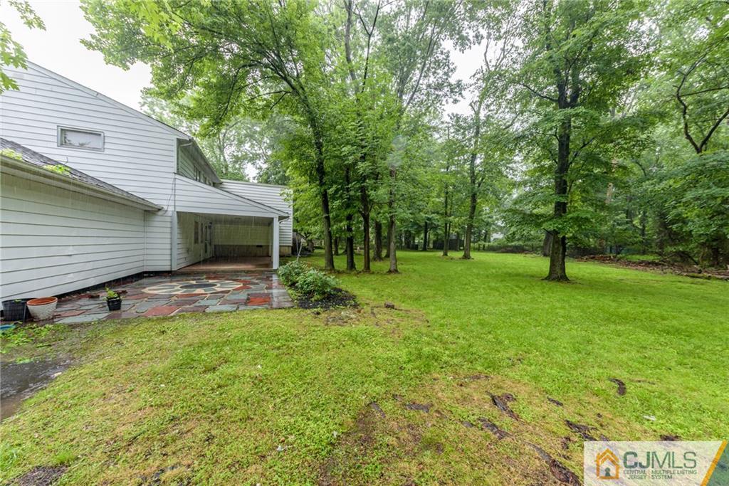 7 Bradford Road Edison, NJ 08820 - Photo 31 of 34 a view of a house with a backyard and a tree