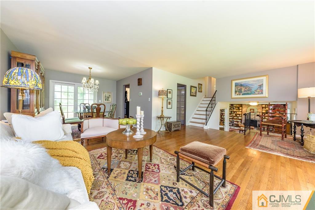 7 Bradford Road Edison, NJ 08820 - Photo 5 of 34 a living room with furniture and a dining table with wooden floor