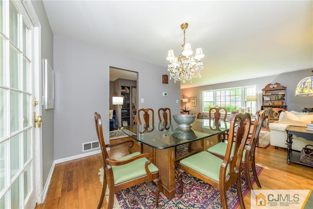 7 Bradford Road Edison, NJ 08820 - Photo 8 of 34 a dining room with furniture a chandelier and wooden floor