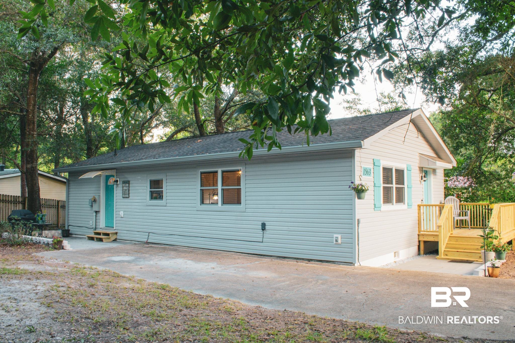 1563 Valencia Drive Lillian, AL 36549 - Photo 27 of 27 Back of property with a wooden deck, entry steps, roof with shingles, and crawl space