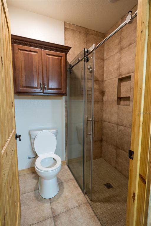 2051 Southeast 155th Street Summerfield, FL 34491 - Photo 27 of 48 a bathroom with a toilet and a shower