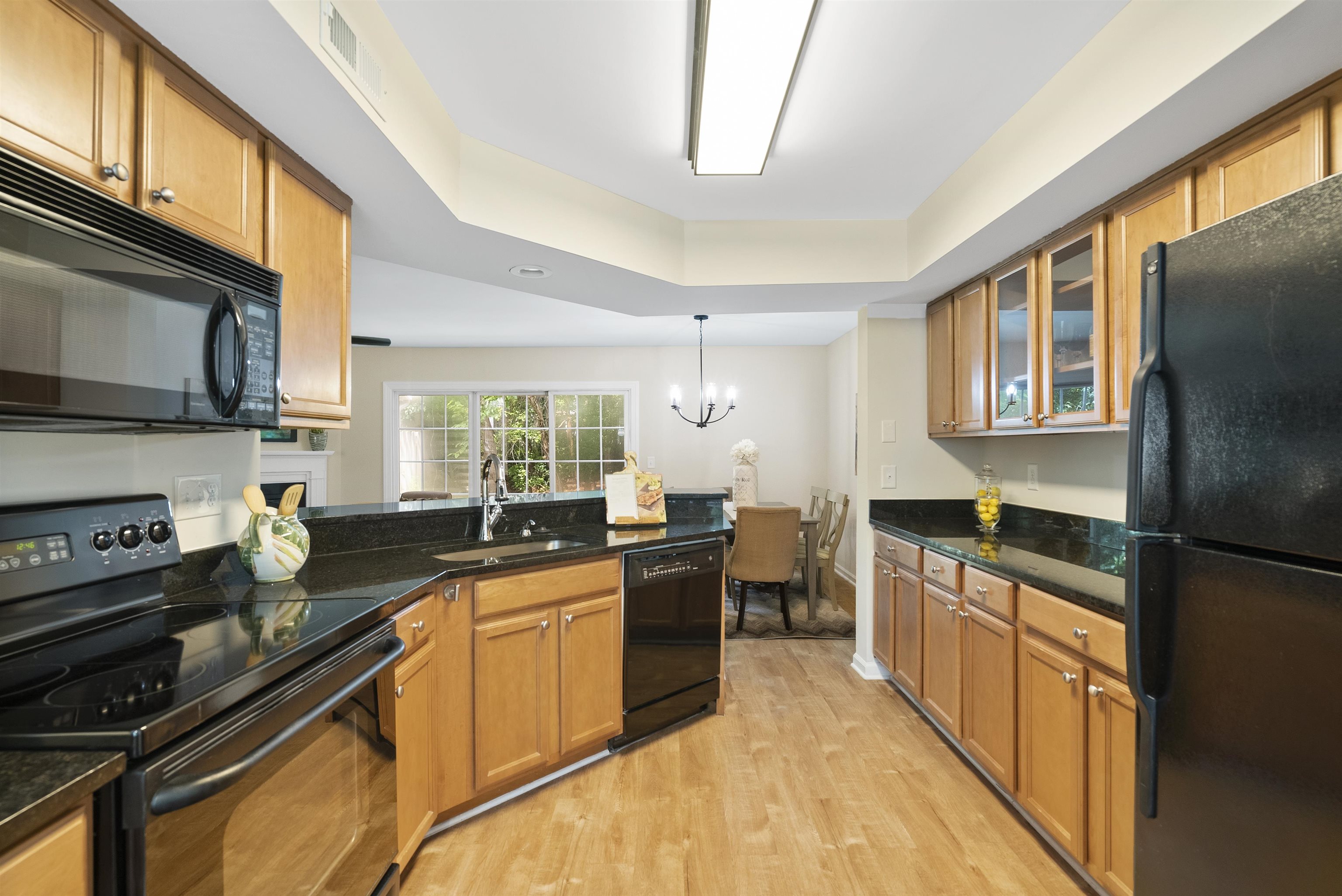 7779 Falcon Rest Circle Raleigh, NC 27615 - Photo 11 of 28 a kitchen with a sink stove top oven and refrigerator