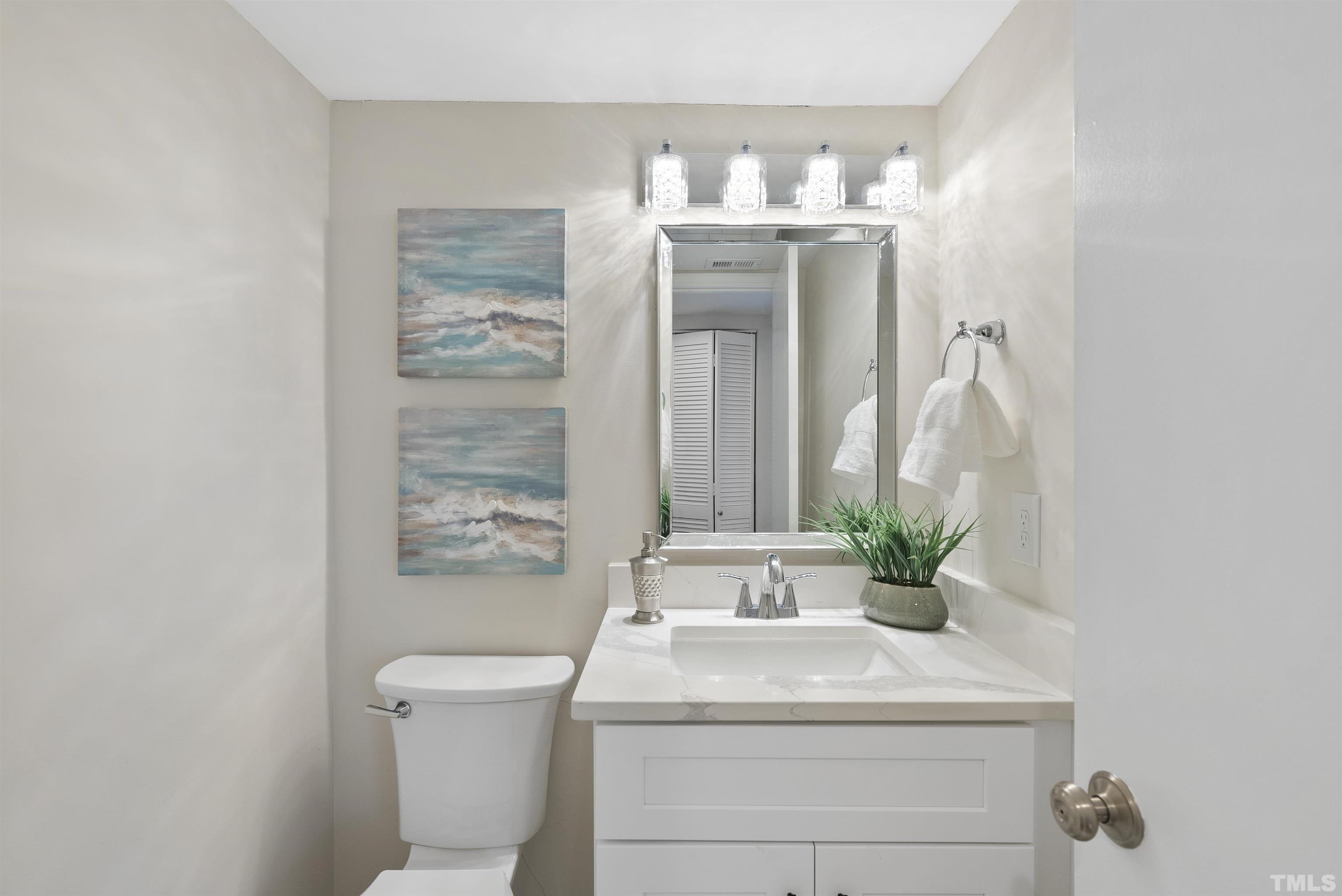 7779 Falcon Rest Circle Raleigh, NC 27615 - Photo 18 of 28 a bathroom with a sink a toilet and mirror