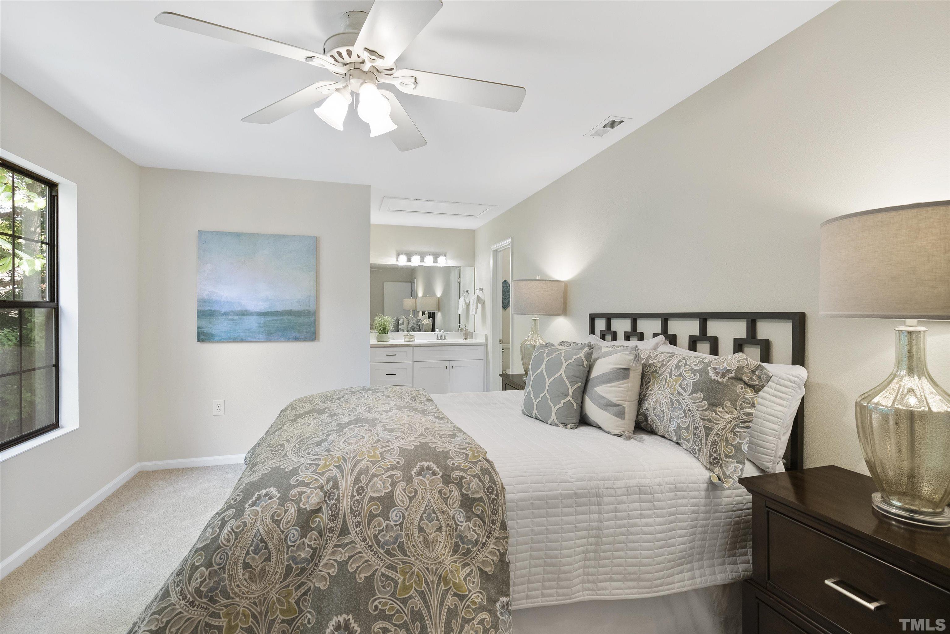 7779 Falcon Rest Circle Raleigh, NC 27615 - Photo 20 of 28 a bedroom with a bed and a painting on the wall