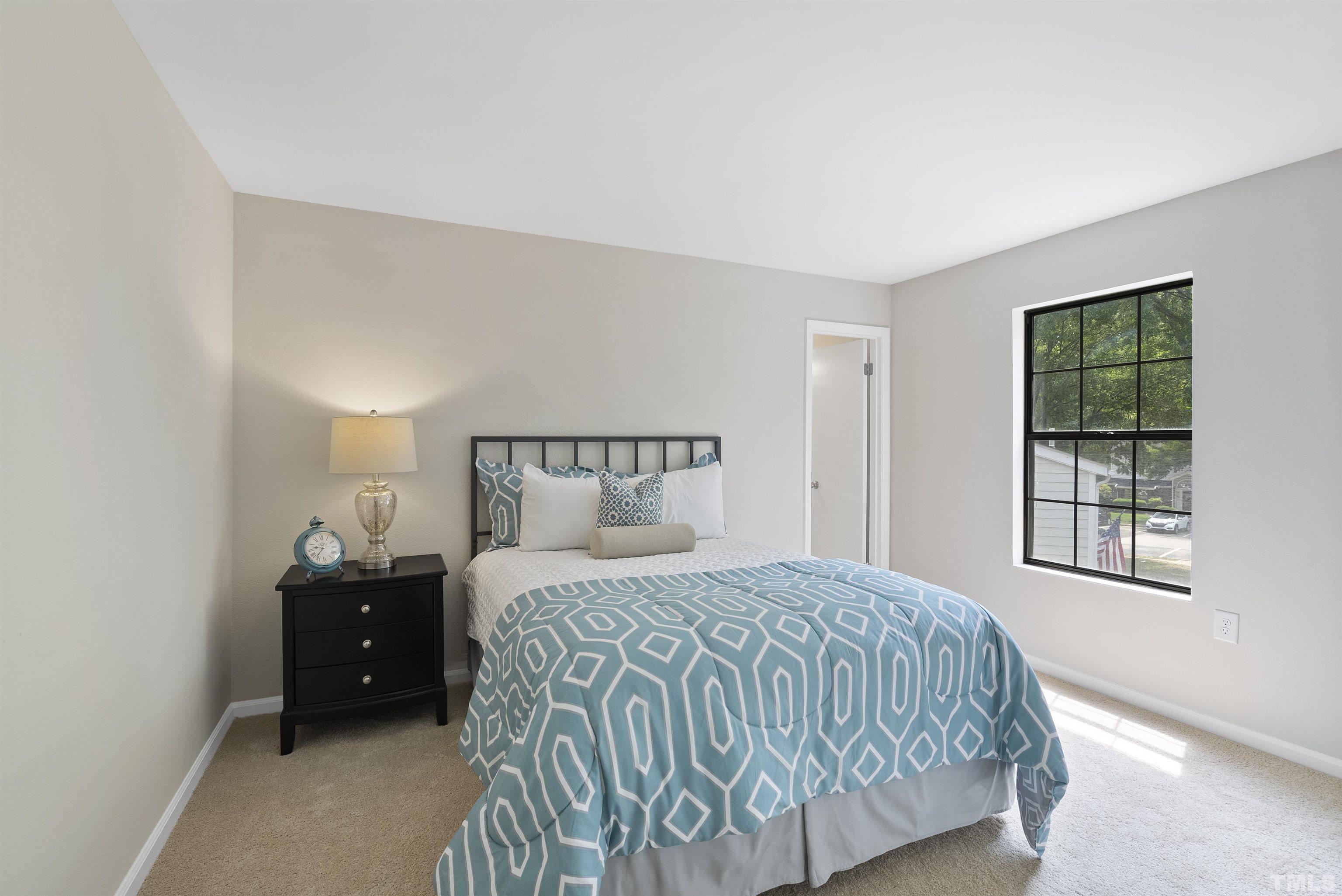 7779 Falcon Rest Circle Raleigh, NC 27615 - Photo 24 of 28 a bedroom with a bed and a window